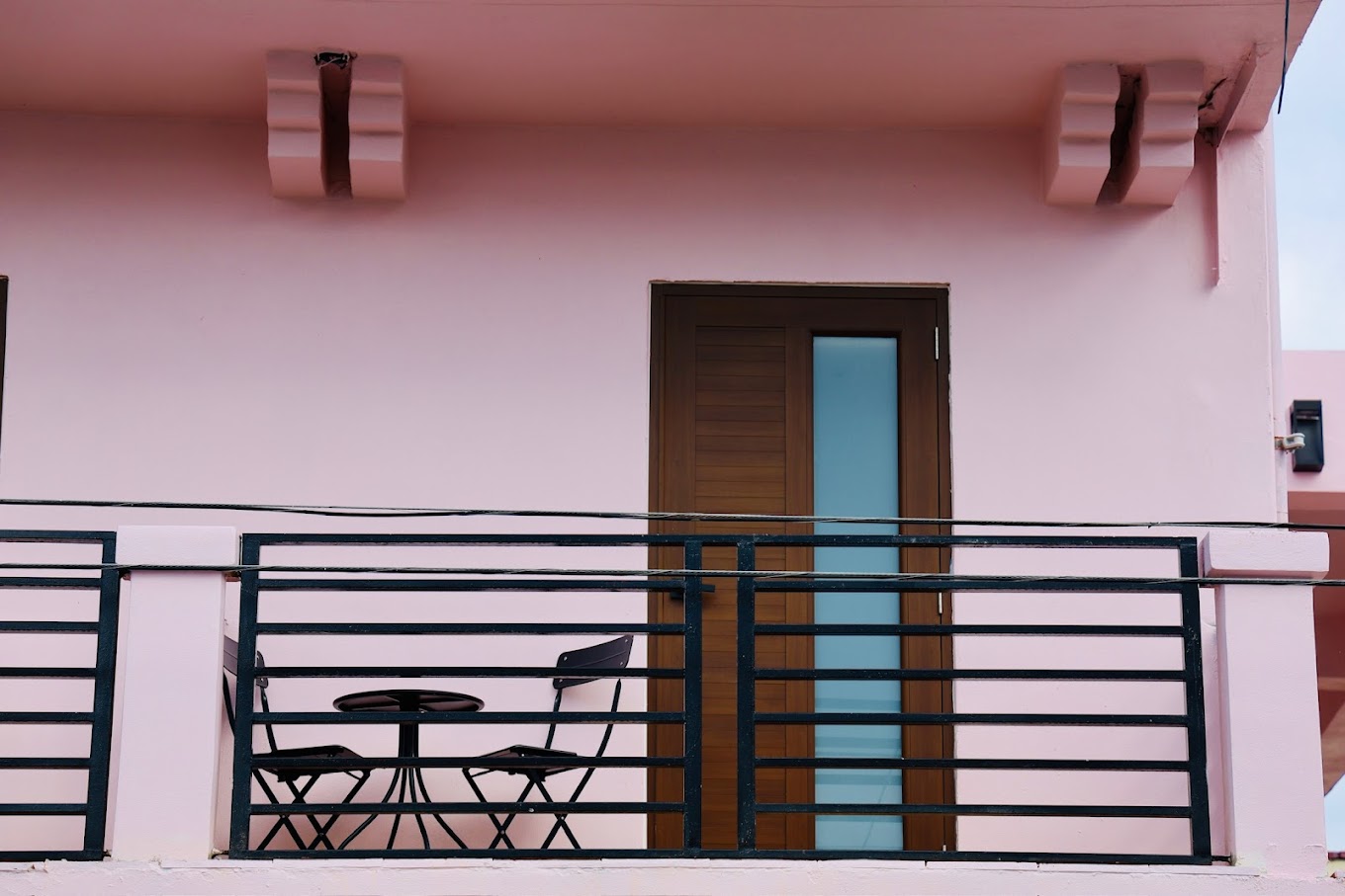 Hotel Luz pink balcony with seating