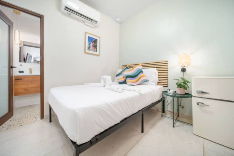 Hotel Luz bedroom with desk and natural light